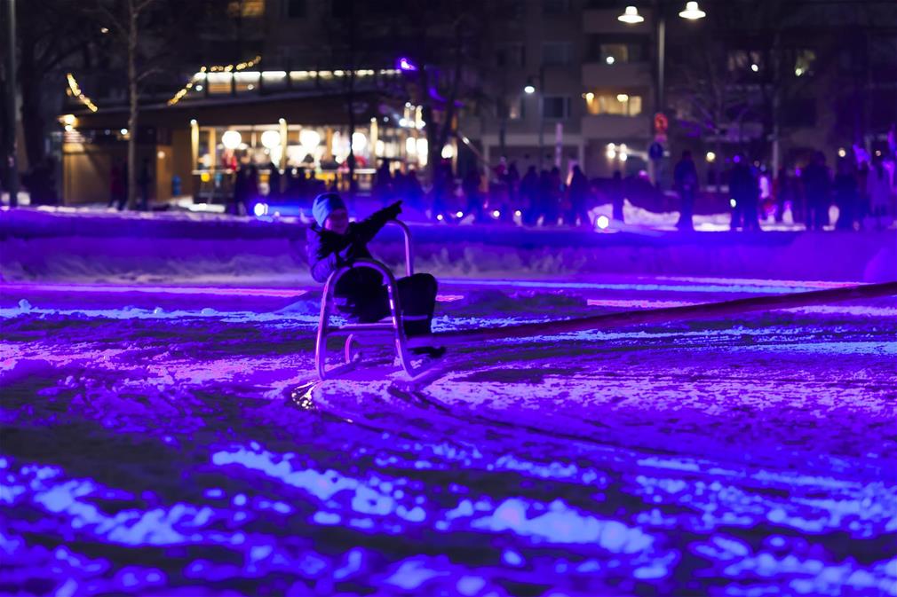 Child in a sleigh on ice.